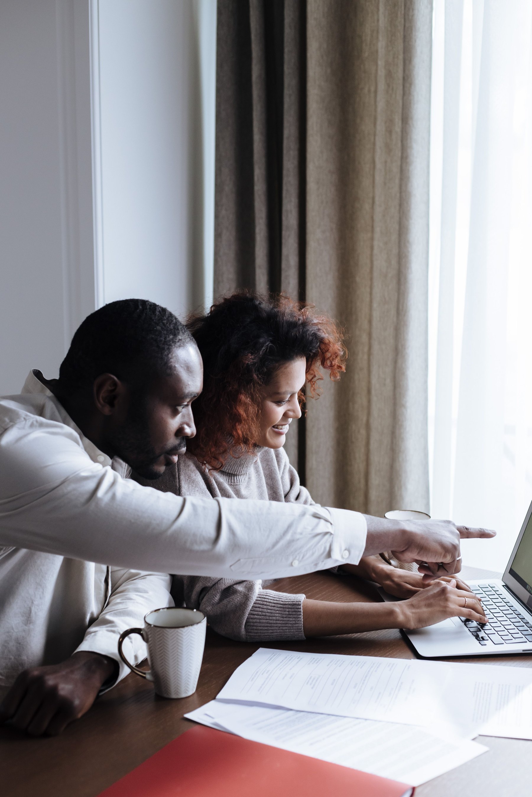 Black woman and Black man reviewing notes together during a supervision conversation